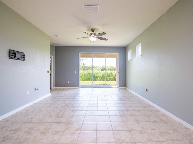 spare room featuring light tile patterned flooring and ceiling fan