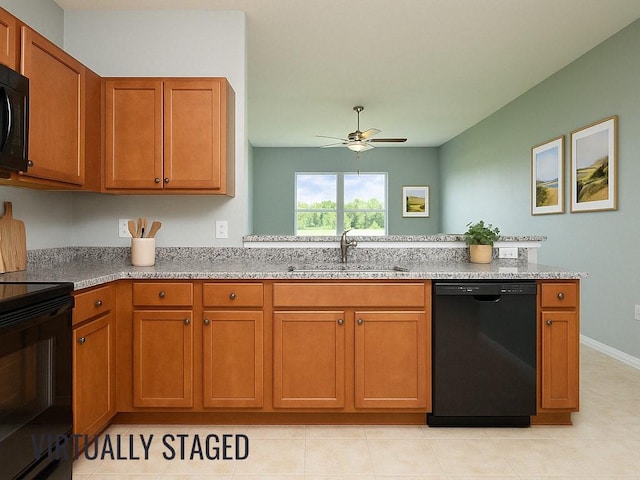 kitchen featuring brown cabinets, a sink, and black appliances