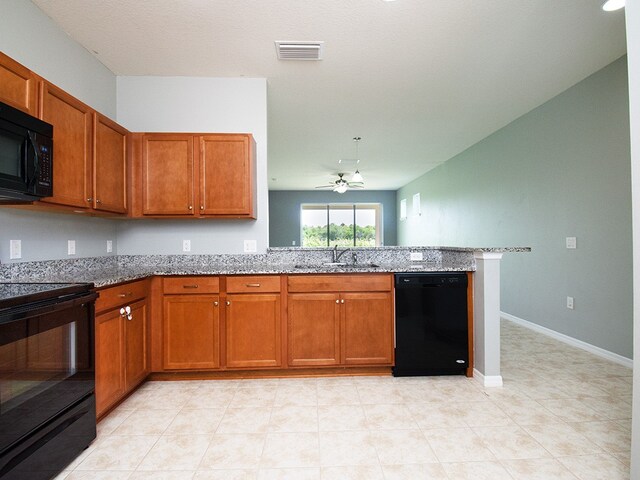 351 Monaco Pl, Vero Beach, FL 32960 - kitchen featuring black appliances, a peninsula, and brown cabinets