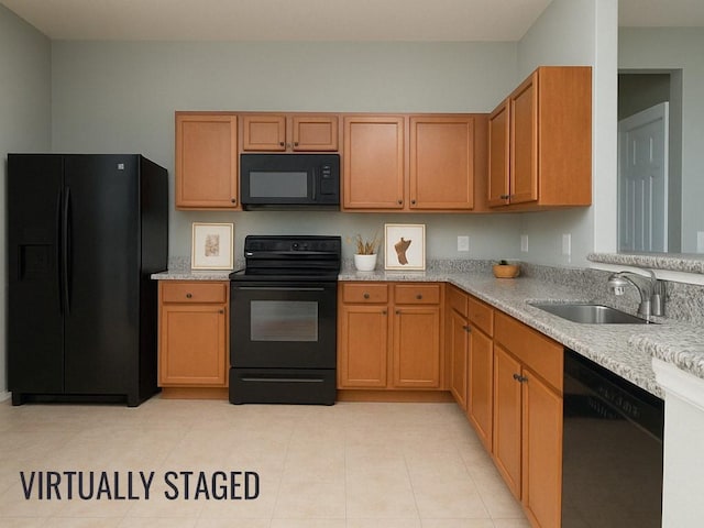 kitchen featuring black appliances, a sink, and light tile patterned floors