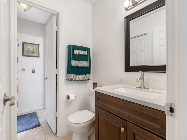 bathroom featuring vanity, tile patterned flooring, and toilet