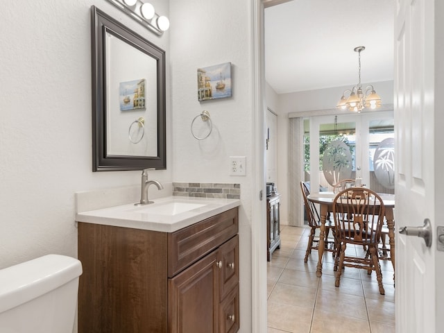 bathroom featuring vanity, a chandelier, tile patterned flooring, and toilet