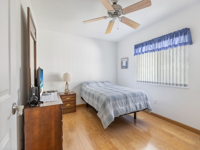 bedroom featuring light hardwood / wood-style flooring and ceiling fan