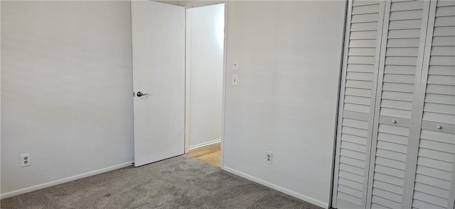 interior space featuring light colored carpet and baseboards