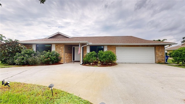 585 W Forest Trl, Vero Beach, FL 32962 - single story home with stone siding, concrete driveway, and an attached garage