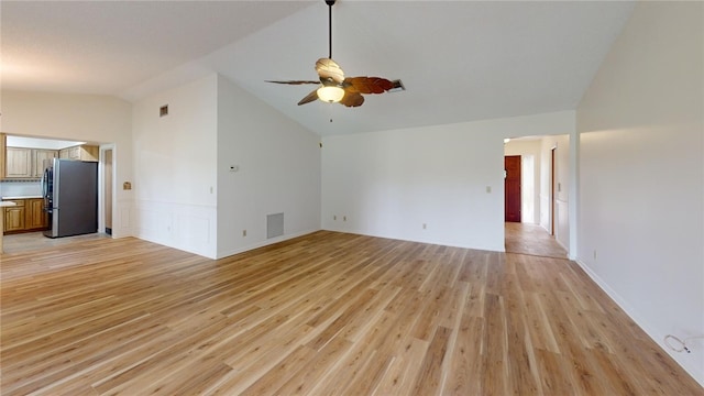 unfurnished living room featuring light wood-type flooring, lofted ceiling, and ceiling fan