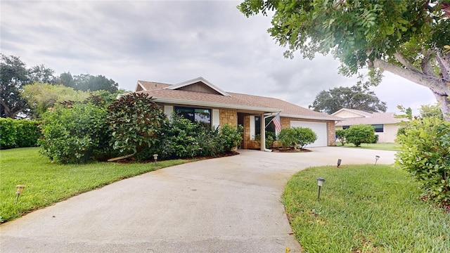 585 W Forest Trl, Vero Beach, FL 32962 - ranch-style home with concrete driveway, a front lawn, an attached garage, and stone siding