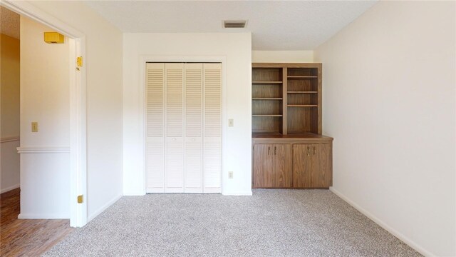 585 W Forest Trl, Vero Beach, FL 32962 - unfurnished bedroom with a closet, carpet, and baseboards