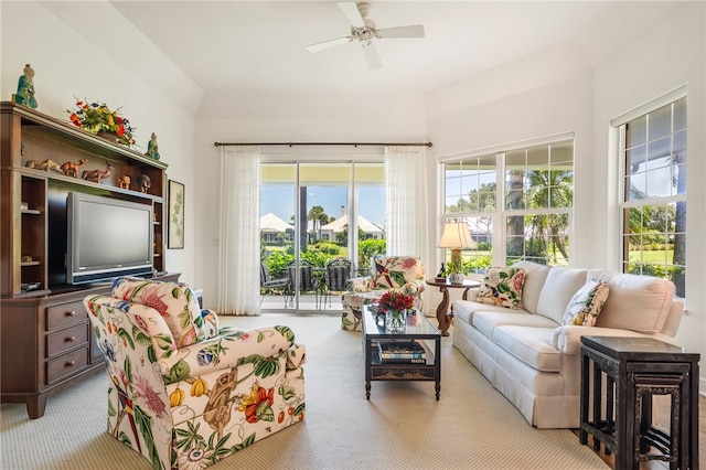 carpeted living room with a wealth of natural light and ceiling fan