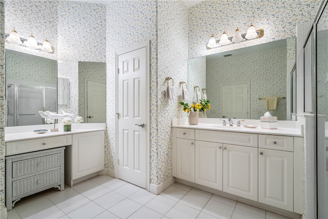 bathroom with tile patterned floors, a shower with door, and vanity