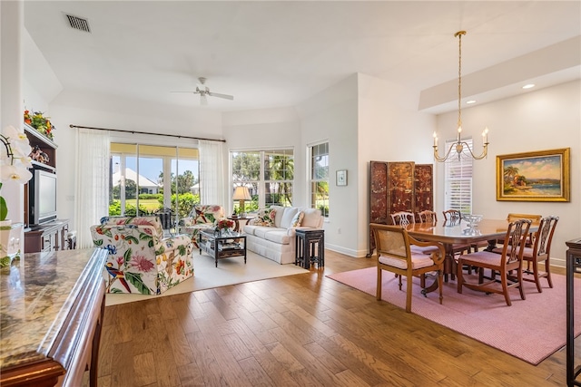 dining room featuring hardwood / wood-style floors and ceiling fan with notable chandelier