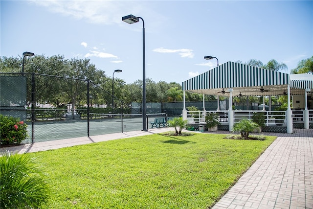 view of sport court with a yard