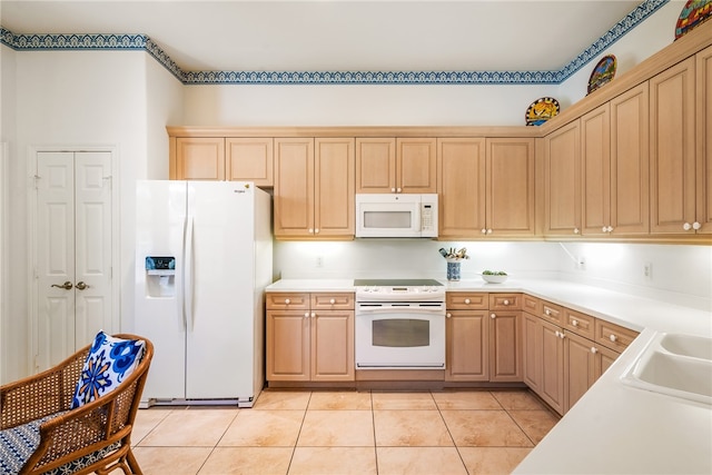 kitchen featuring light brown cabinets, white appliances, light tile patterned floors, and sink