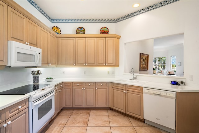 kitchen featuring light tile patterned floors, white appliances, light brown cabinets, and sink