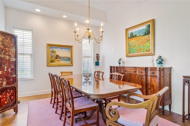 dining room featuring light hardwood / wood-style flooring and a notable chandelier