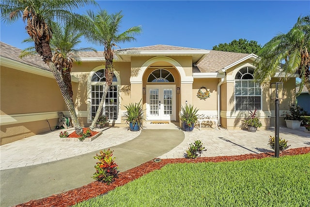 view of exterior entry featuring french doors