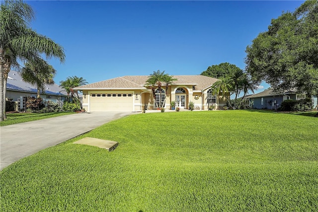 view of front of house with a garage and a front lawn