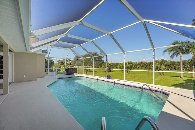 view of pool with a patio, a yard, and a lanai