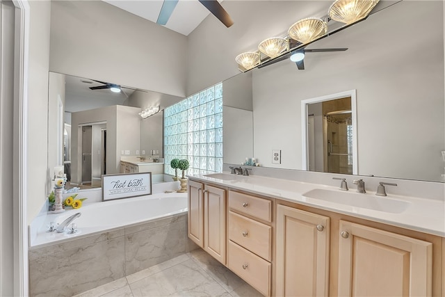 bathroom with ceiling fan, vanity, and plus walk in shower