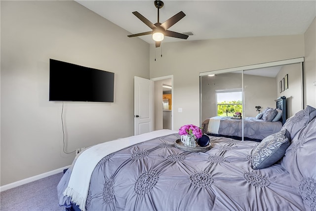 carpeted bedroom featuring ceiling fan, a closet, and lofted ceiling