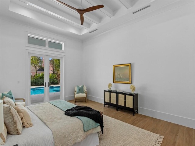 bedroom featuring visible vents, beamed ceiling, wood finished floors, access to exterior, and french doors