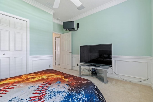 728 S Ocracoke Sq SW, Vero Beach, FL 32968 - bedroom featuring crown molding, carpet flooring, wainscoting, a closet, and a ceiling fan