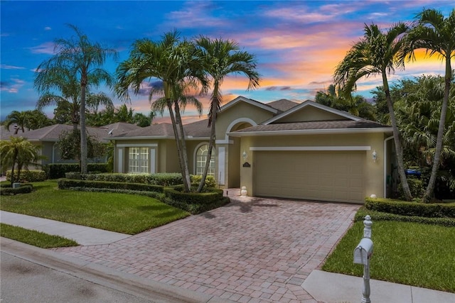 728 S Ocracoke Sq SW, Vero Beach, FL 32968 - single story home with decorative driveway, stucco siding, a garage, and a yard
