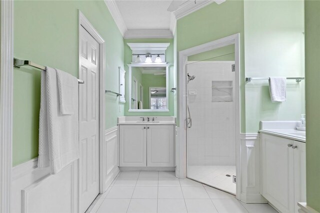 728 S Ocracoke Sq SW, Vero Beach, FL 32968 - bathroom featuring a stall shower, vanity, crown molding, a wainscoted wall, and tile patterned floors
