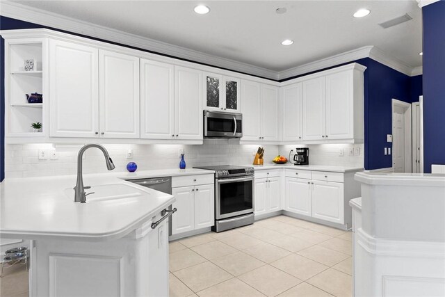 728 S Ocracoke Sq SW, Vero Beach, FL 32968 - kitchen featuring appliances with stainless steel finishes, a sink, a peninsula, light countertops, and white cabinets