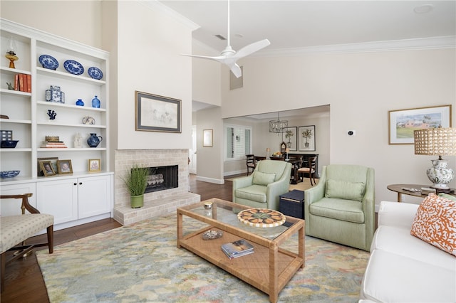 2139 Via Fuentes St Unit 2139, Vero Beach, FL 32963 - living room with crown molding, wood finished floors, a ceiling fan, and a brick fireplace