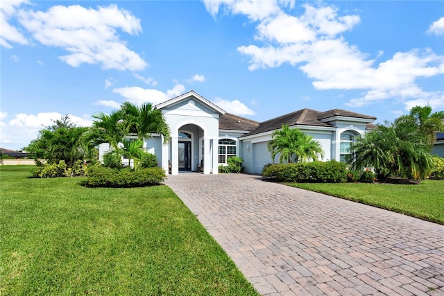 view of front of property with a front yard and a garage