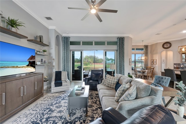 living room featuring ceiling fan and crown molding