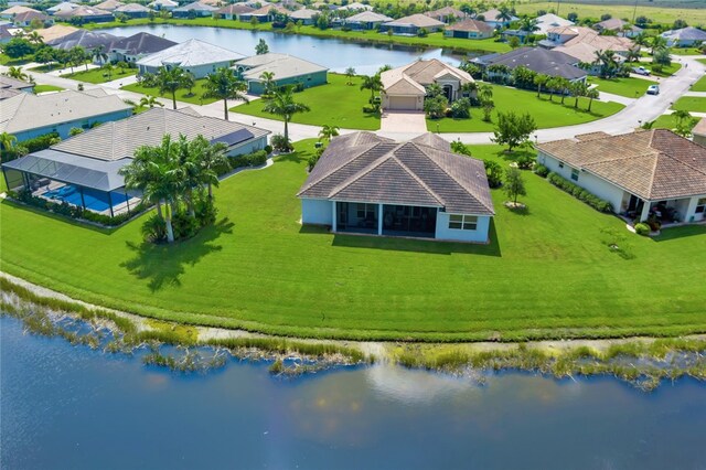 birds eye view of property with a water view