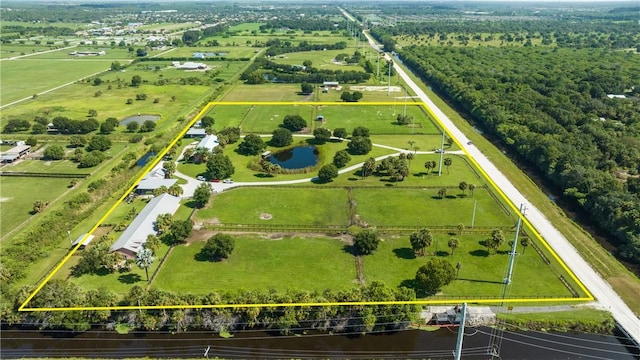 birds eye view of property featuring a water view and a rural view