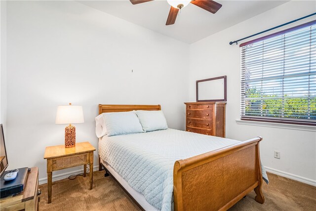 bedroom featuring ceiling fan, carpet flooring, and baseboards