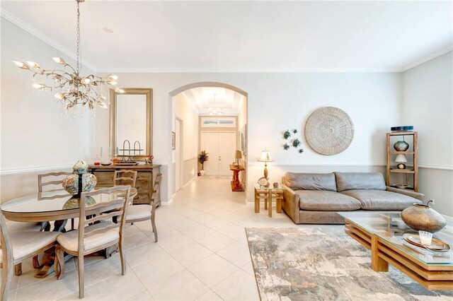 living room with crown molding, arched walkways, a chandelier, and light tile patterned floors