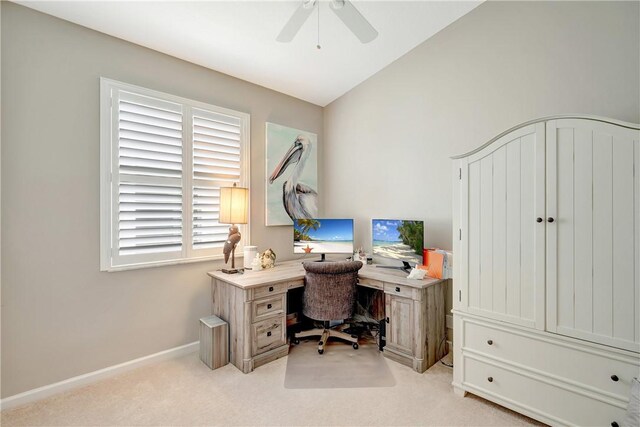 office featuring plenty of natural light, a ceiling fan, baseboards, and light carpet