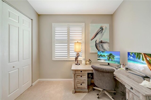 carpeted home office with baseboards