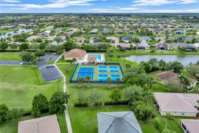drone / aerial view featuring a residential view and a water view