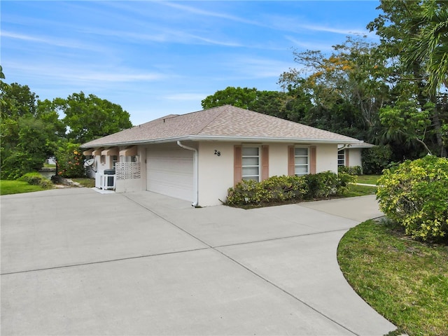 28 Sea Gull Ave, Vero Beach, FL 32960 - view of front facade featuring a shingled roof, driveway, stucco siding, and a garage