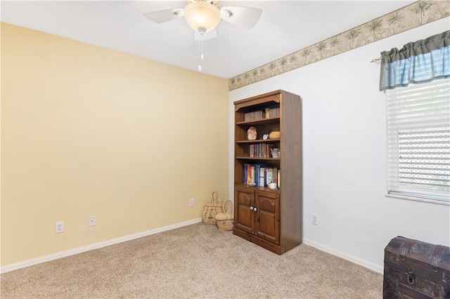 carpeted spare room with ceiling fan