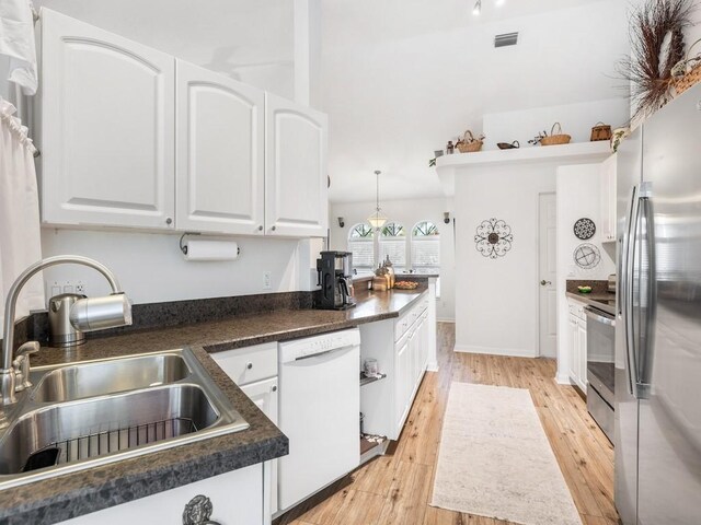 kitchen with sink, stainless steel appliances, light hardwood / wood-style floors, and white cabinets