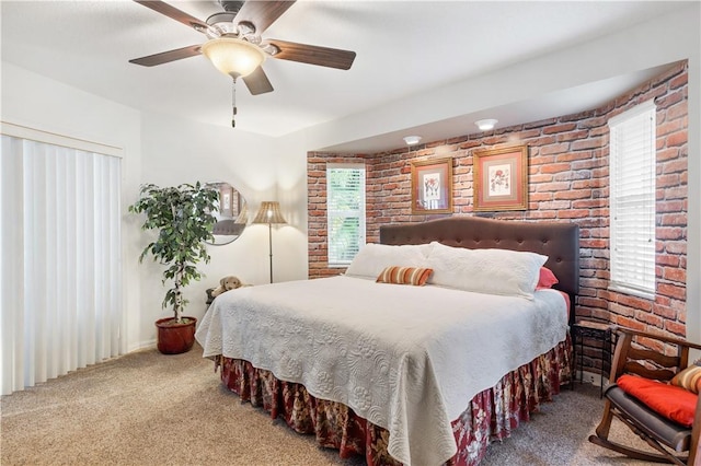 carpeted bedroom featuring ceiling fan and brick wall