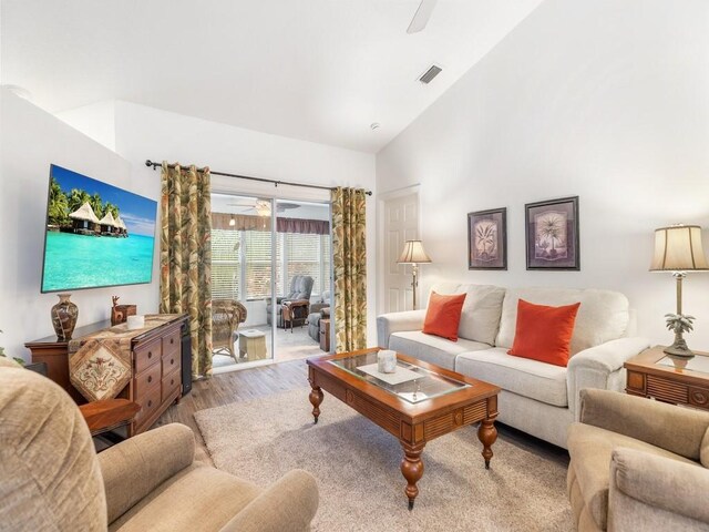 living room with high vaulted ceiling, hardwood / wood-style floors, and ceiling fan