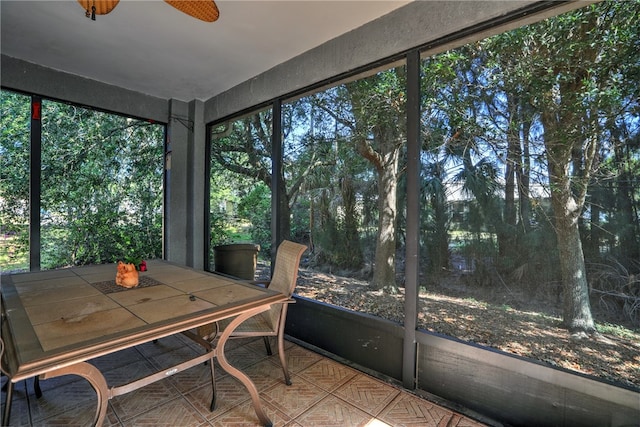 sunroom / solarium with a wealth of natural light and ceiling fan