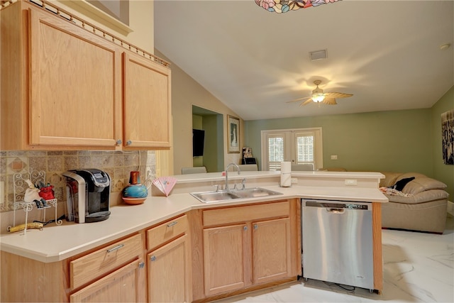 kitchen with sink, kitchen peninsula, light brown cabinets, dishwasher, and vaulted ceiling