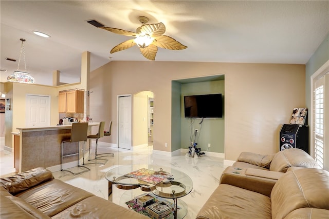 living room featuring ceiling fan and lofted ceiling