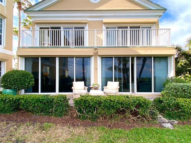 rear view of property featuring a balcony