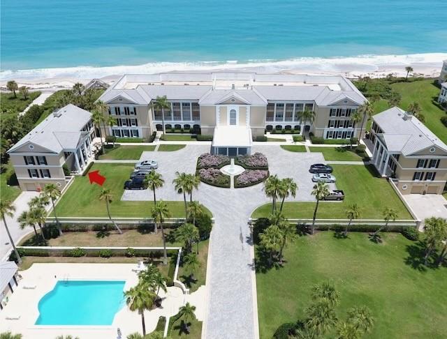 drone / aerial view featuring a water view and a beach view