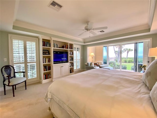 bedroom with ornamental molding, access to outside, ceiling fan, a raised ceiling, and light carpet